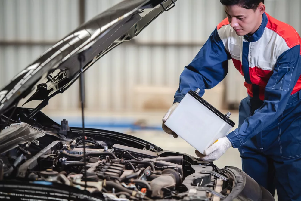 Ken's automotive and transmissions replacing car battery