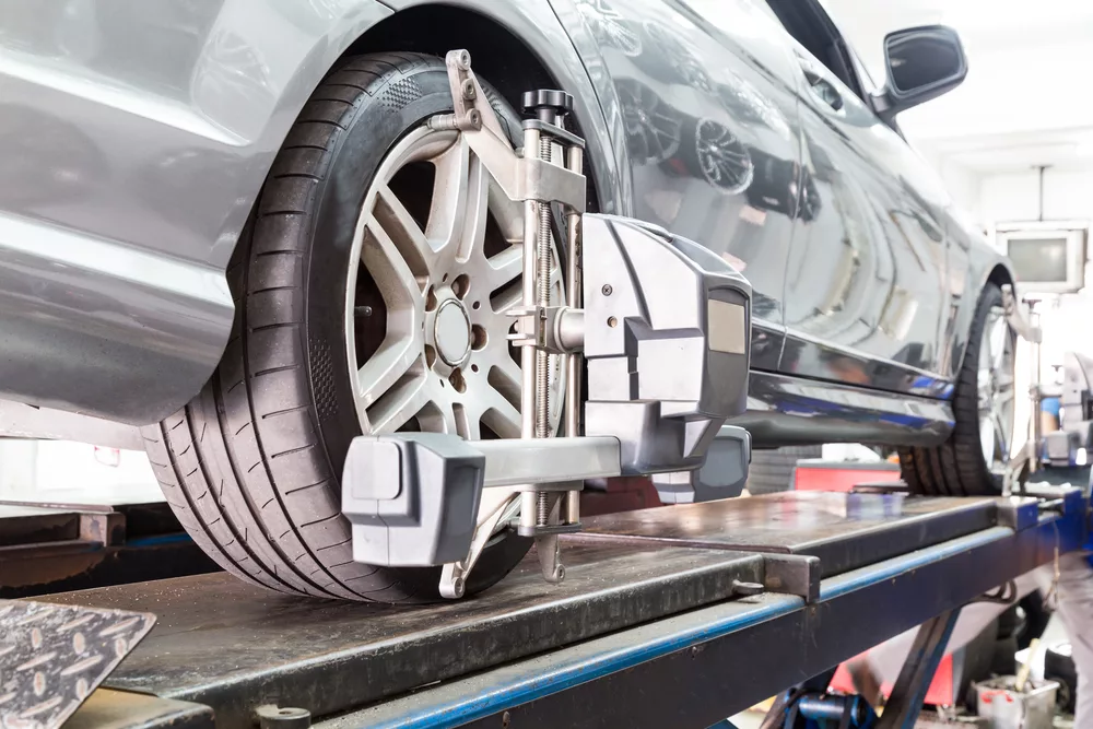 Ken's automotive and transmissions car on lift for alignment