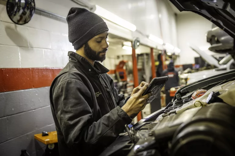 Ken's automotive and transmissions mechanic repairing under hood computer