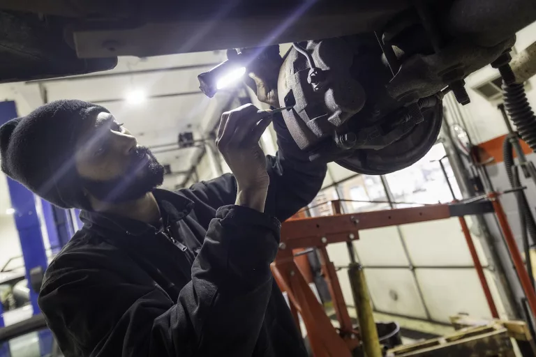 Ken's automotive and transmissions mechanic repairing brakes rotor