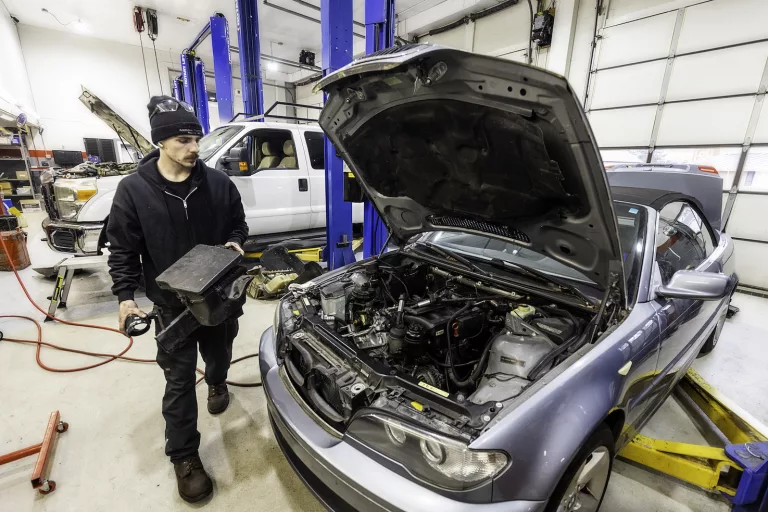 Ken's automotive and transmissions mechanic replacing repairing car part