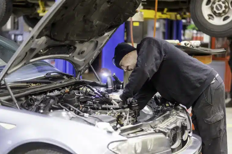 Ken's automotive and transmissions mechanic working on engine