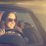 Happy woman in cabriolet car
