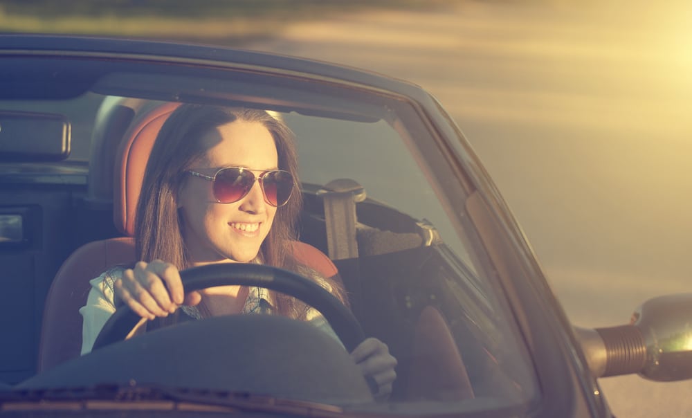 How to Keep Your Engine Cool During Peak Heat 1 Happy woman in cabriolet car