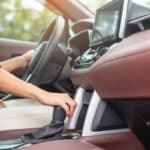 woman driver stick shift transmission a car gear, hand controlling steering wheel during vehicle moving. Journey, trip and safety Transportation concepts